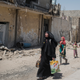 Iraqi civilians flee the Islamic State controlled Old City of west Mosul on June 23, 2017. Image via Getty.
